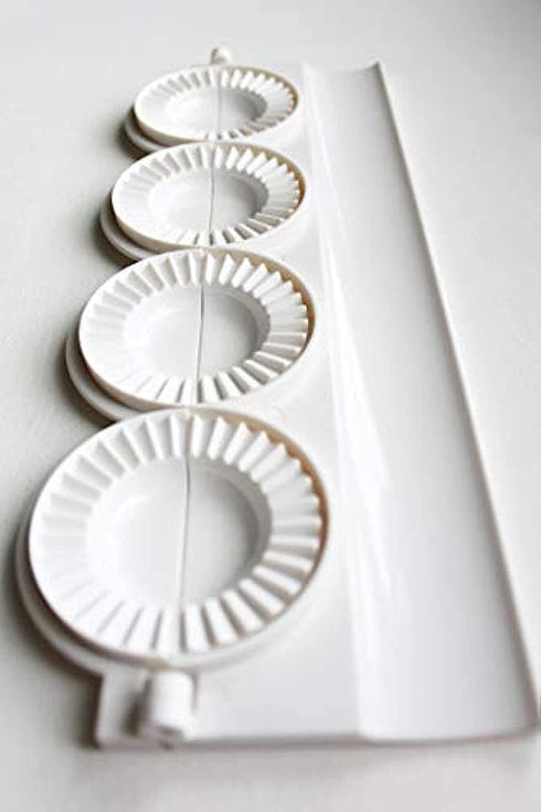 small pierogies, dumplings, uszka press/maker. Makes four small pierogies at once...