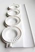 small pierogies, dumplings, uszka press/maker. Makes four small pierogies at once...