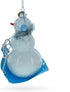 Snowman Riding a Sled Blown Glass Christmas Ornament...