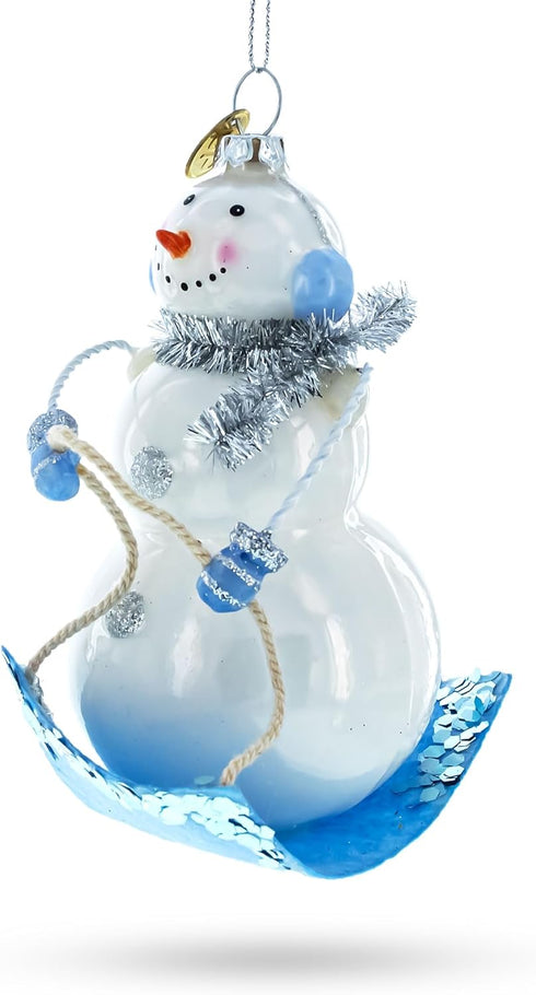 Snowman Riding a Sled Blown Glass Christmas Ornament...