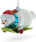 Snowman Gleefully Riding a Sled Glass Christmas Ornament...
