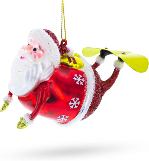 Santa Snowboarding Blown Glass Christmas Ornament...