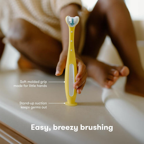 Frida Baby Triple-Angle Toothhugger Training Toddler Toothbrush | Toddler Toothbrush 2 Years and Up, Cleans All Sides at Once | Yellow...