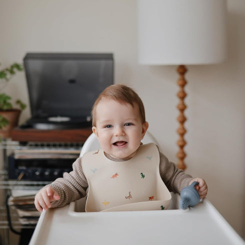 mushie Silicone Baby Bib | Adjustable Fit Waterproof Bibs (Dinosaurs)...