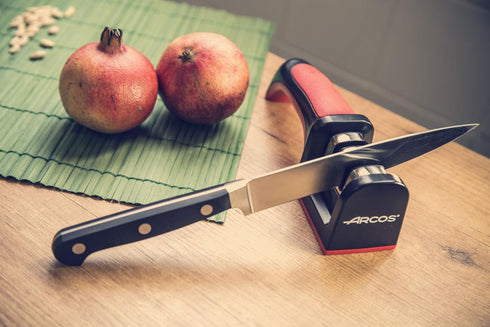 Arcos Sharpeners Manual Knife Sharpener tool. Made of ABS + TPE. Carbide and Ceramic Rollers. Keep Your Knives Razor Sharp. Black and Red Color...