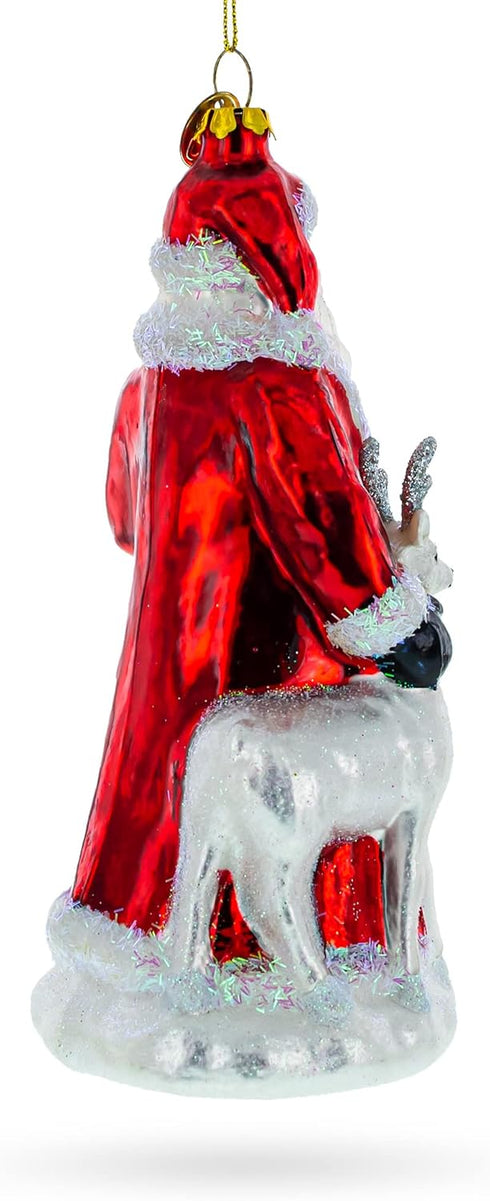 Santa Guided by White Reindeer Glass Christmas Ornament...