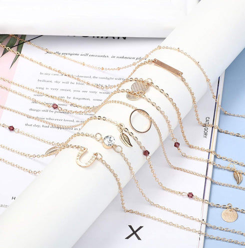 JOERICA 16 Pcs Gold Layered Necklaces Choker Chain Y Necklace Set for Women Disc Bar Shell Feather Horn Blessed Virgin Mary Pendant Necklace Jewel...