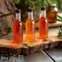 Mini Plastic Bottles with Lids (24 Pack) - Empty 1.7oz Shot Bottles - Small Miniature Bottles for Alcohol, Spirits, Liquor - Funnel Included...