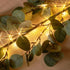 Hairui Lighted Artificial Eucalyptus Garland 6FT 96 LED Battery Operated Faux Vine Lights with Timer for Spring Wedding Backdrop Wall Decor...