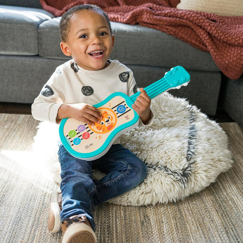 Baby Einstein Sing & Strum Magic Touch Ukulele Wooden Musical Toy, Ages 6 Months+, Multicolored...