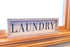 The Country House Laundry Farmhouse Distressed White 16 x 5 Rustic Wood Decorative Sign Plaque